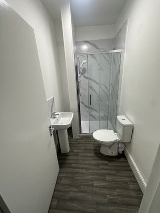 A Modern Bathroom Featuring A Sleek Walk-In Shower...