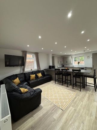 Spacious And Modern Living Room Featuring Ample Se...