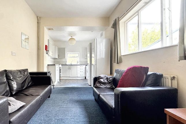 A Spacious And Inviting Living Room With Large Win...