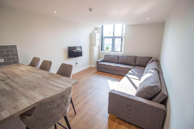 A Spacious And Bright Living Room Featuring Modern...