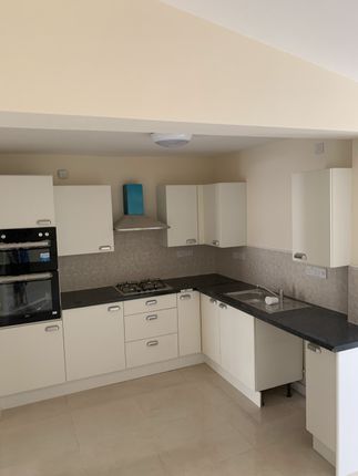 A Clean And Well-Lit Kitchen With Modern Appliance...