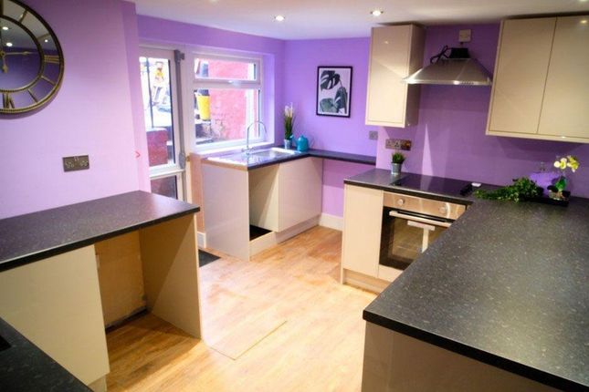 Bright And Modern Kitchen Featuring Light Wood Flo...