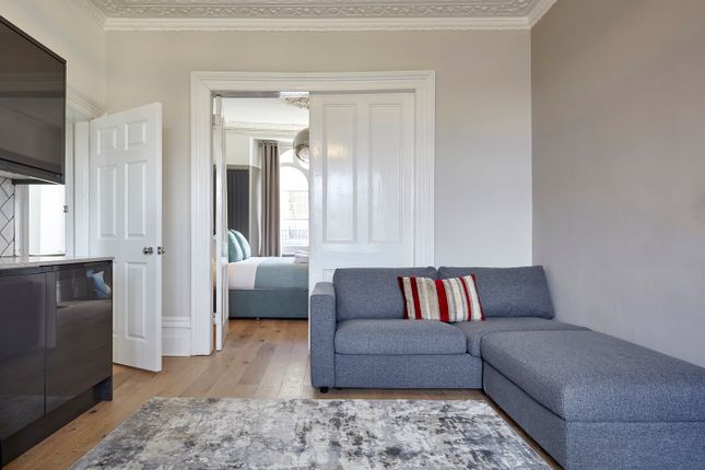 A Clean And Inviting Living Room Featuring A Grey ...