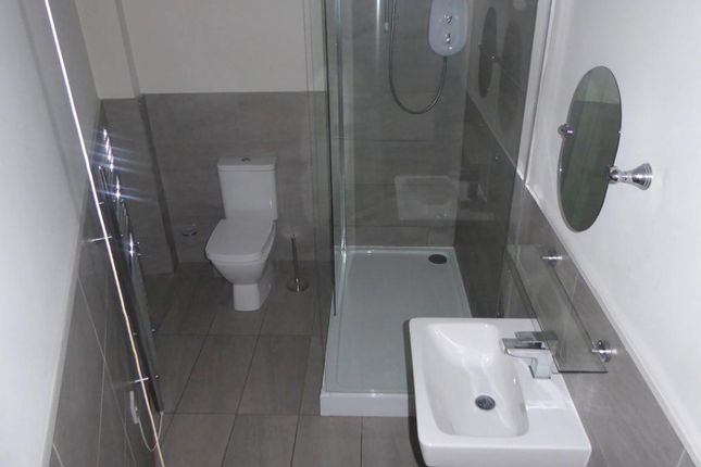 A Modern And Clean Bathroom Featuring A Shower, To...