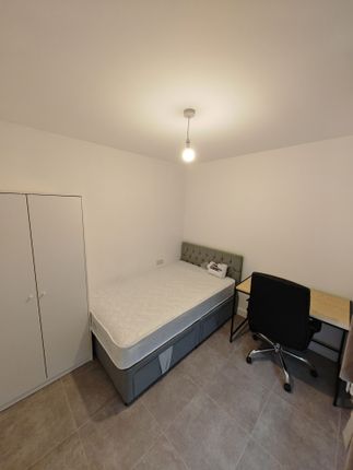 A Neat And Tidy Single Bedroom Featuring A Comfort...