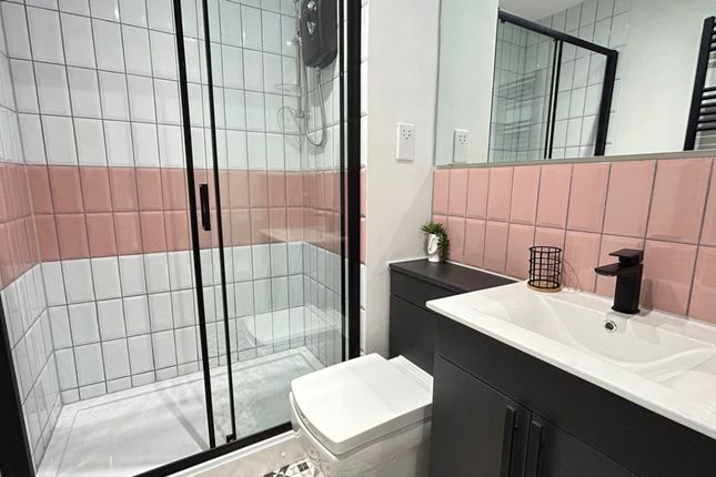 A Modern Bathroom Featuring A Walk-In Shower, Styl...