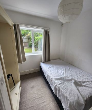 A Cozy Single Bedroom Featuring A Comfortable Bed ...