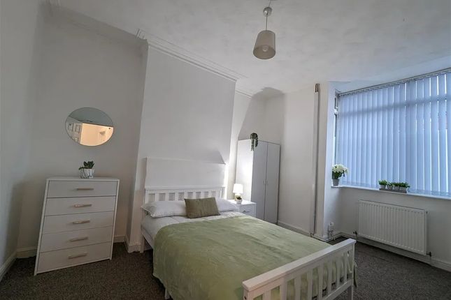 A Bright And Tidy Bedroom With A Comfortable Doubl...