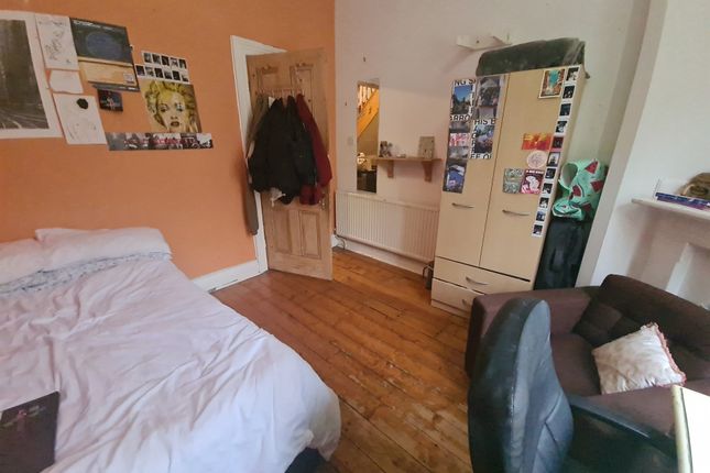 A Cozy Double Bedroom With Warm Wooden Flooring An...