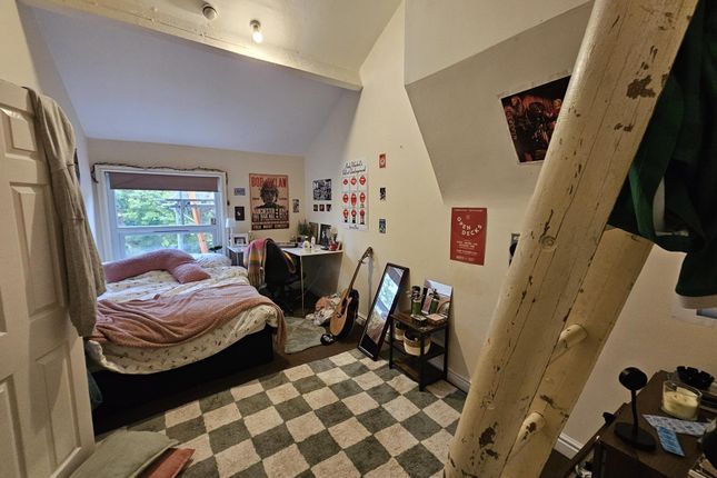 A Cozy Bedroom With A Large Window Filling The Roo...