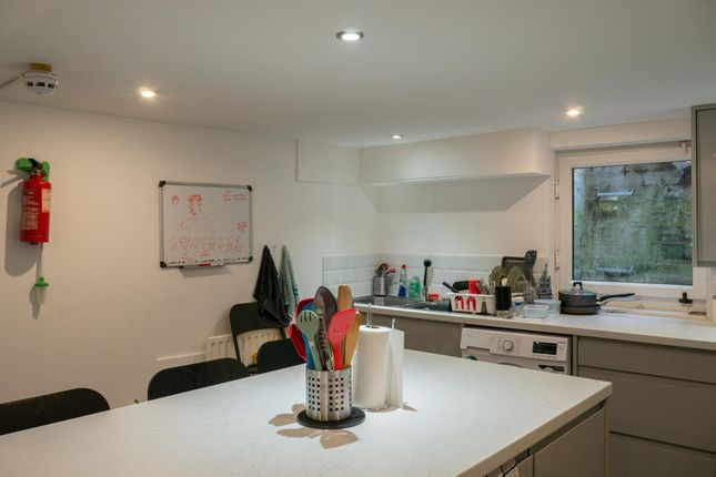 A Bright And Tidy Kitchen Area Featuring Modern Ap...