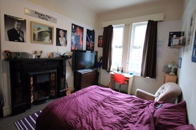 A Cozy And Inviting Master Bedroom Featuring A Com...