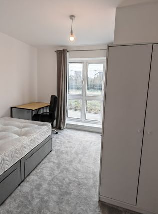 A Bright And Tidy Single Bedroom Featuring A Large...