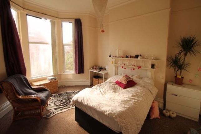 A Bright And Cozy Master Bedroom Featuring A Comfo...