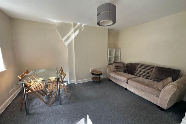 A Bright And Welcoming Living Room Featuring A Com...