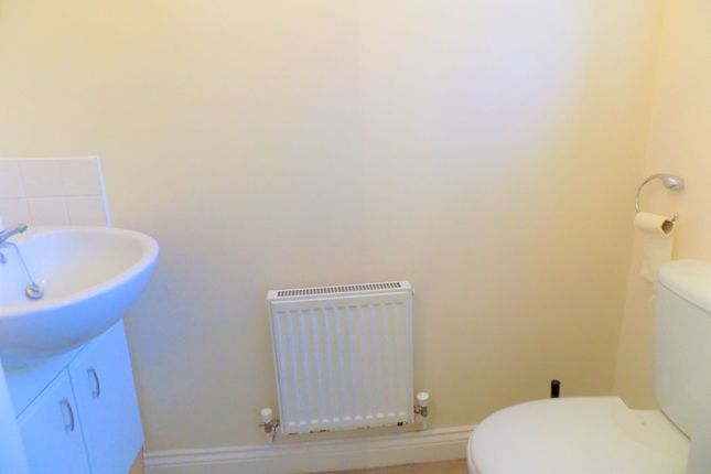 A Clean And Simple Toilet Room Featuring A White B...