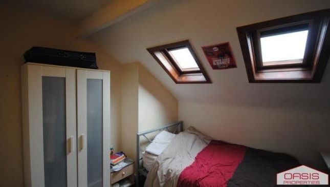 A Cozy Bedroom Featuring A Double Bed, Illuminated...