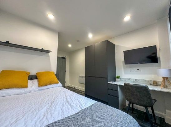 A Modern Double Bedroom Featuring A Comfortable Be...
