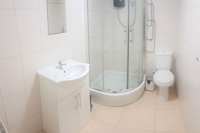 Bright, Modern Bathroom With A Corner Glass Shower...