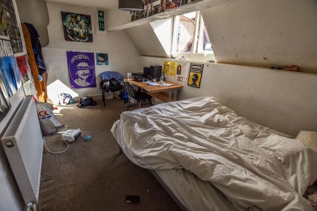 Cozy Single Bedroom With A Slanted Ceiling And Two...
