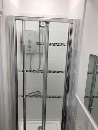 A Modern, Clean Bathroom Featuring A Spacious Show...