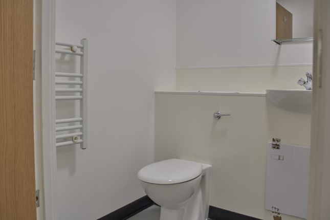 A Tidy And Functional Single Toilet With Modern fi...