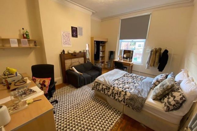 A Cozy Double Bedroom Featuring Two Beds, A Desk W...