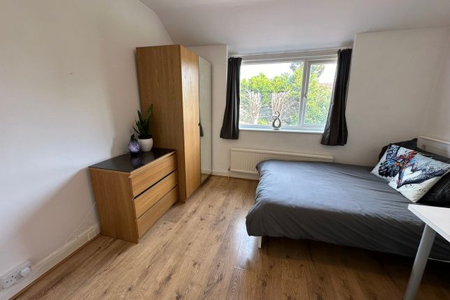 A Cozy Double Bedroom Featuring Stylish Wooden Fur...
