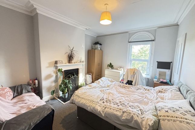 A Bright And Welcoming Bedroom Featuring A Comfort...