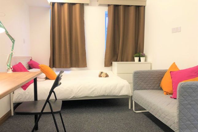 A Bright And Tidy Single Bedroom Featuring A Comfo...