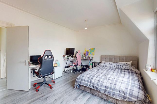 A Bright And Spacious Bedroom Featuring A Comforta...