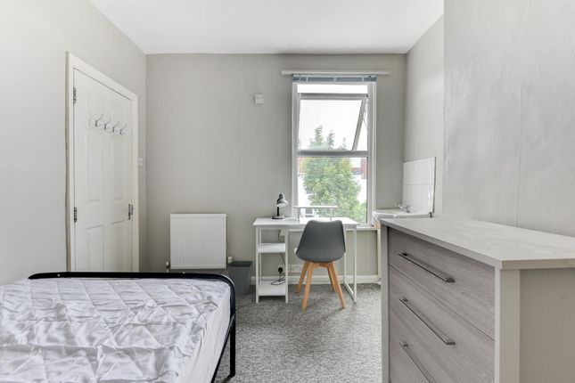 A Bright And Tidy Bedroom Featuring A Large Window...