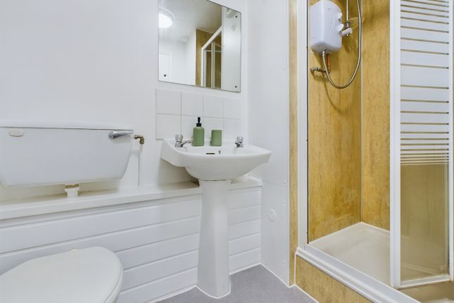 A Bright And Tidy Bathroom Featuring A Modern Show...