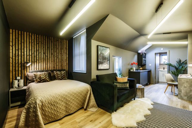 A Stylish And Spacious Master Bedroom Featuring A ...