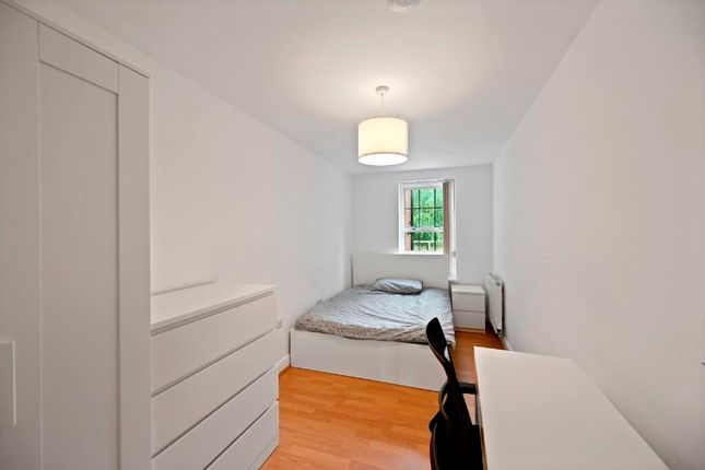A Neat And Simple Bedroom Featuring A Comfortable ...