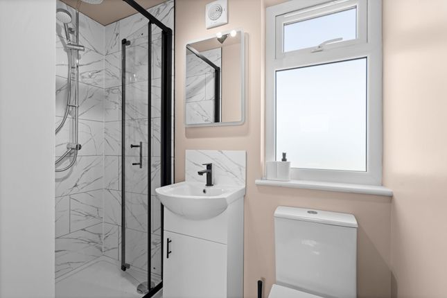 A Modern Bathroom Featuring A Sleek Walk-In Shower...