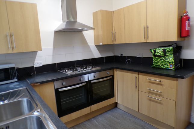 A Functional And Tidy Kitchen With Modern Applianc...
