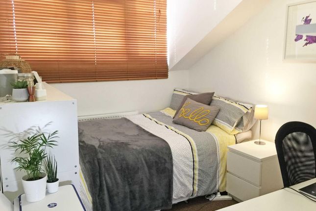 Cozy, Neatly Made Bedroom With Soft Grey And Yello...