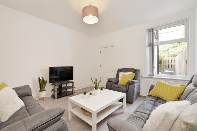 Bright And Inviting Living Room Featuring Comforta...