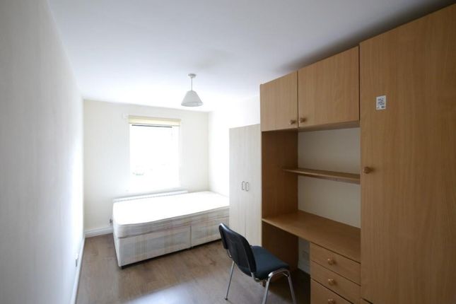 A Compact, Tidy Single Bedroom Featuring A Bed Pos...