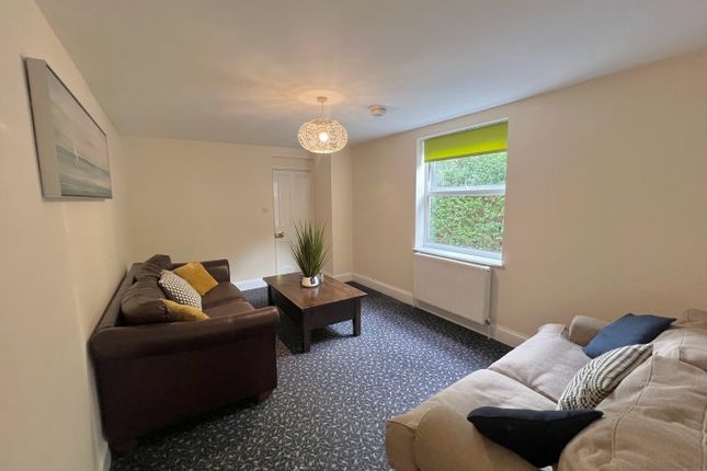 A Spacious And Inviting Living Room With Modern De...