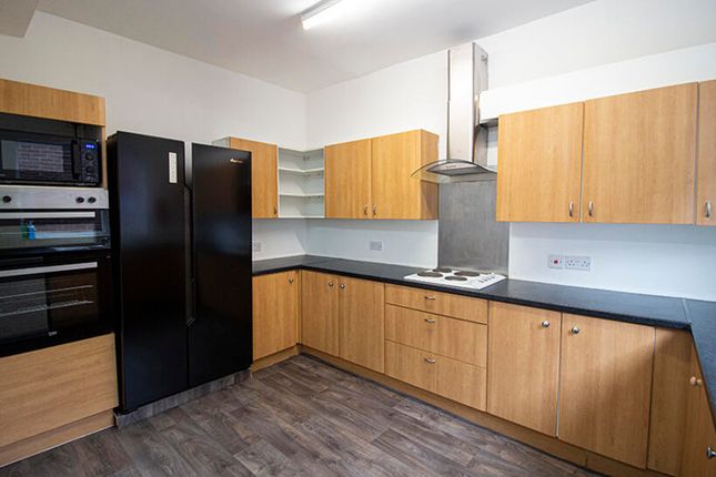 A Modern Kitchen Featuring Sleek Wooden Cabinetry,...