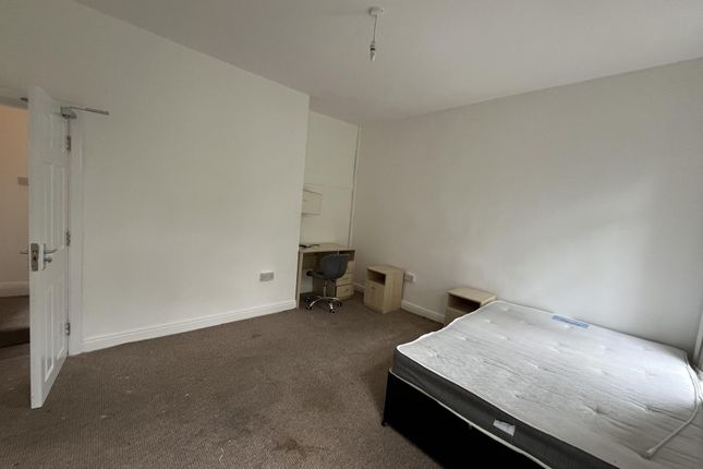 A Simple, Well-Lit Single Bedroom With A Bed And N...