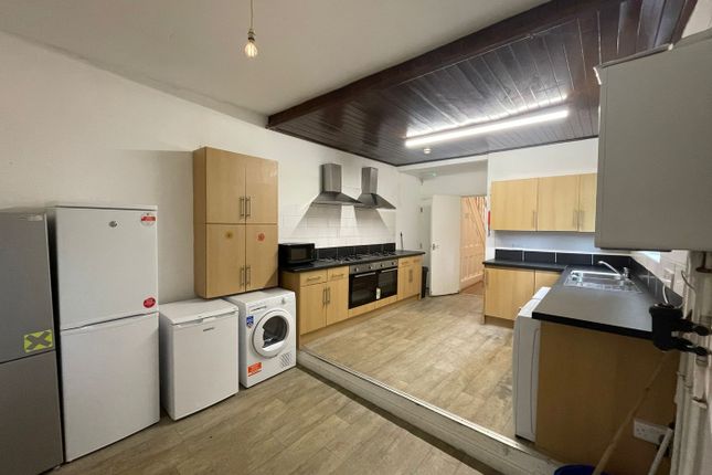 A Spacious And Modern Kitchen Equipped With Essent...