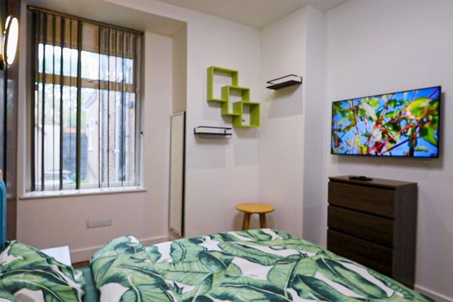 A Cozy Single Bedroom Featuring A Comfortable Bed ...