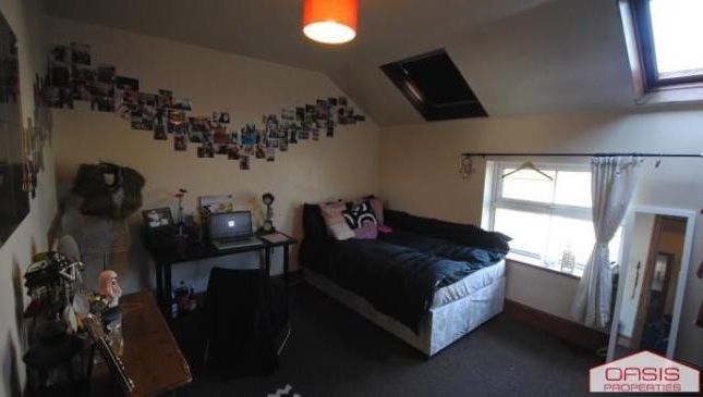 A Well-Maintained Bedroom Featuring A Double Bed, ...