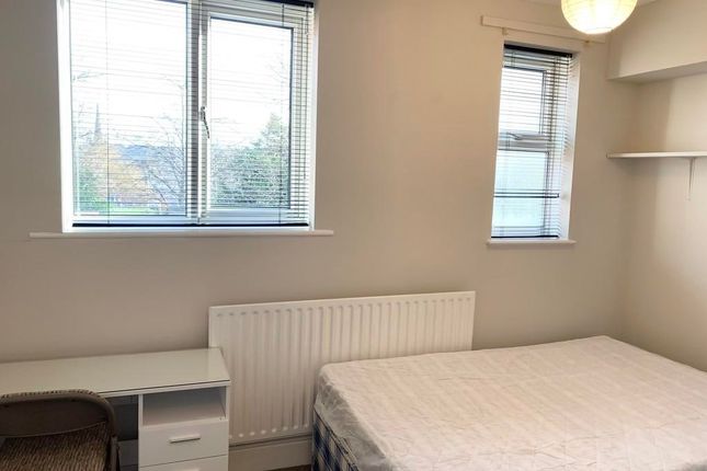 A Bright Double Bedroom Featuring Two Large Window...