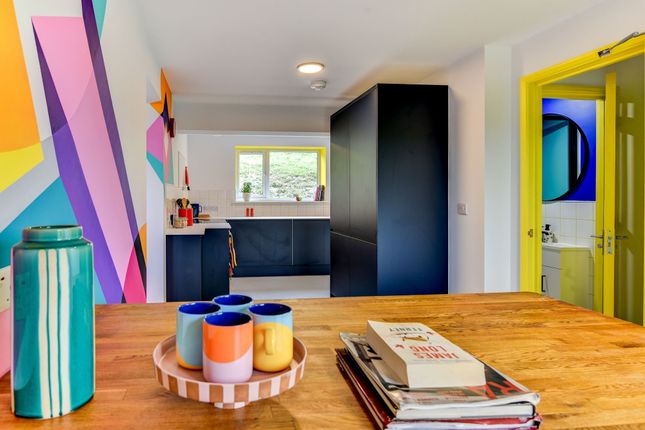This Vibrant Kitchen Features A Modern Design With...