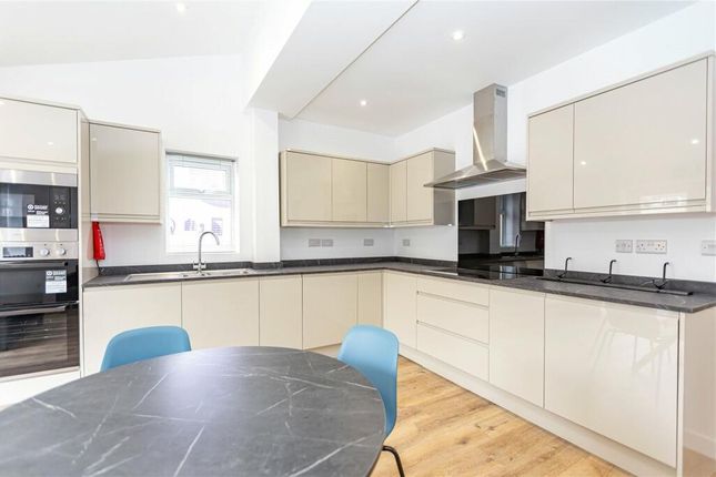 Bright And Modern Kitchen Featuring Sleek Cream Ca...