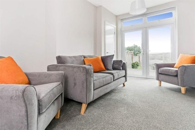 Bright And Inviting Living Room Featuring Comforta...